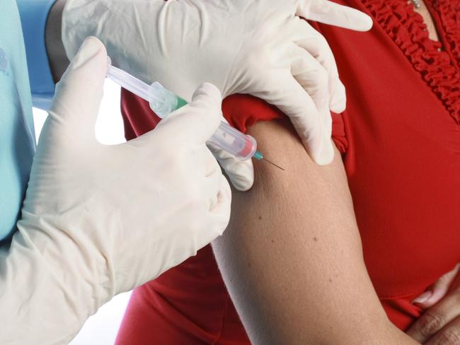 Generic photo of a person getting a flu shot. vaccination / needle / doctor / patient. Picture: iStock