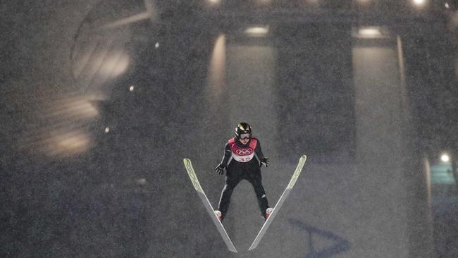 Maren Lundby soars through the snow amid freezing conditions in the women's normal hill individual ski jumping. Picture: AP