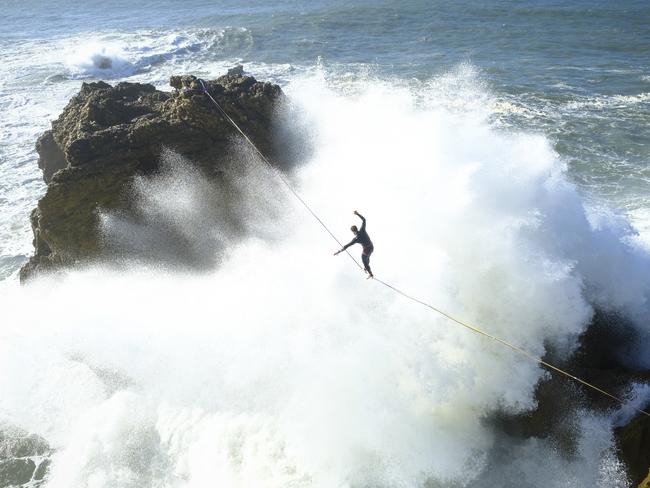 A Portuguese highlining group pushing the limits as they walked along a 2.5cm wide tightrope. Picture: Aidan Williams