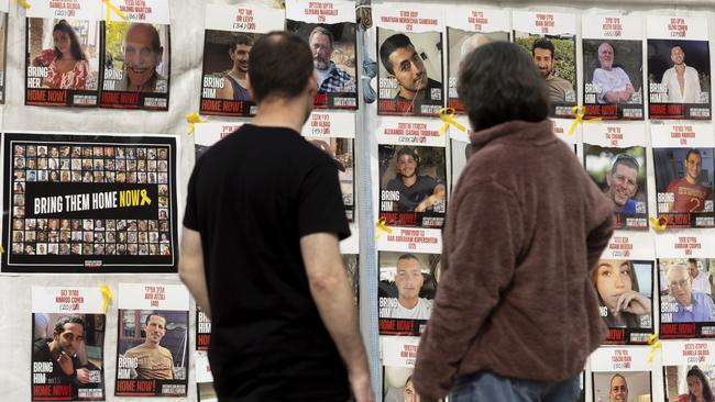 People look at a wall covered with photos of hostages held in the Gaza Strip after the deadly Oct 7 Hamas attack on January 17, 2025 in Tel Aviv, Israel. Picture: Getty