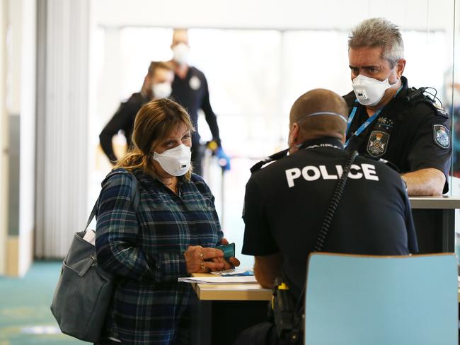 A passenger who flew with Jetstar to Sunshine Coast airport from Melbourne goes through questioning with Queensland Police on arrival. Photo Lachie Millard