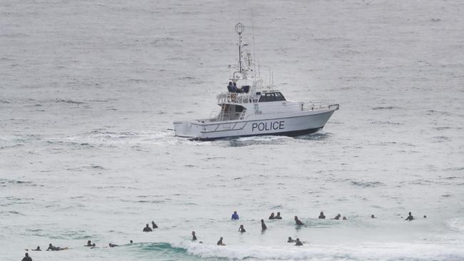 Queensland Water Police patrol the scene of the fatal shark attack at Coolangatta. Picture: Scott Powick