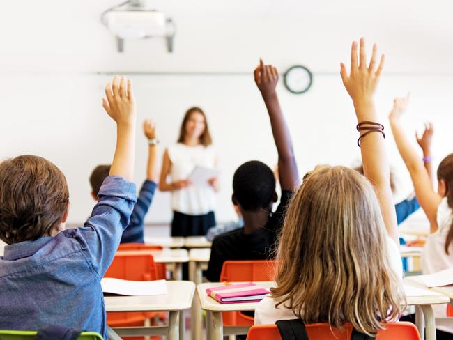 School kids in classroom. Generic (stock) photo of children in a classroom with teacher in background.Picture: iStock