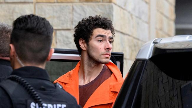 HOLLIDAYSBURG, PENNSYLVANIA - DECEMBER 10: Luigi Mangione is led into the Blair County Courthouse for an extradition hearing December 10, 2024 in Hollidaysburg, Pennsylvania. Mangione has been arraigned on weapons and false identification charges related to the fatal shooting of United Healthcare CEO Brian Thompson in New York City. Mangione is incarcerated in the State Correctional Institution in Huntingdon, Pennsylvania awaiting extradition to New York.   Jeff Swensen/Getty Images/AFP (Photo by JEFF SWENSEN / GETTY IMAGES NORTH AMERICA / Getty Images via AFP)