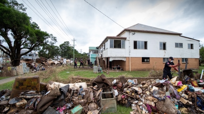 Residents cleaning up a house in South Lismore with crews from NSW. Picture: NCA NewsWire