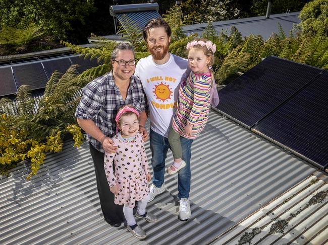 Kim and Rusty Blake with their daughters Tahlia, 8 and Esther, 4 with their recently installed solar panels. Picture: Jake Nowakowski