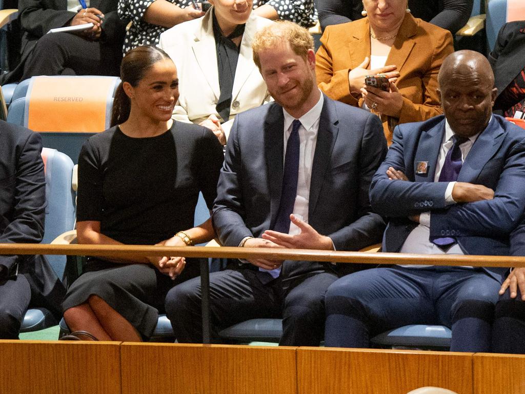 The couple wait for Prince Harry’s bombshell speech. Picture: AFP