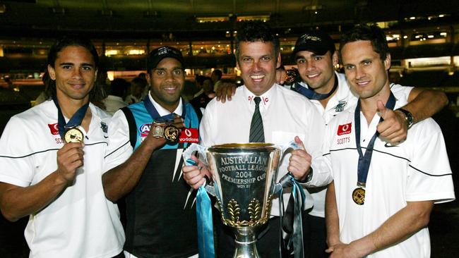 Port coach Mark Williams with his indigenous players Peter Burgoyne, Byron Pickett, Shaun Burgoyne and Gavin Wanganeen after the 2004 grand final.                        <a capiid="e74cc268e77411332e8517271d7e883a" class="capi-video">Special round for Motlop</a>