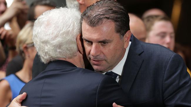 Frank Lowy and Socceroos coach Ange Postecoglou embrace during celebrations.