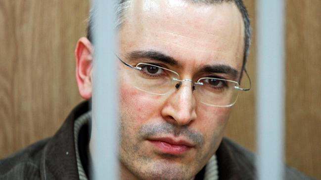 Russian oil tycoon Mikhail Khodorkovsky seen behind bars at a courtroom, at the start of a trial in Moscow in 2004.