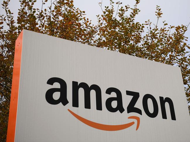 (FILES) In this file photo taken on November 27, 2019 an Amazon sign is pictured at the Amazon Fulfilment Centre in Peterborough, east England, as preparations are underway for the annual Black Friday Sale. - Amazon, supported by the e-commerce boom with the Covid-19 pandemic, created 25,000 permanent jobs in the UK last year, far more than the 10,000 new positions the group initially planned in the country, announced Amazon on February 2, 2022. (Photo by Daniel LEAL / AFP)