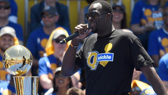 Draymond Green #23 of the Golden State Warriors talks to the fans wearing a ‘Quickie’ shirt.