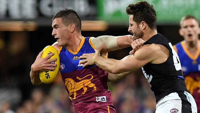 Tom Rockliff pushes away Blue Matthew Wright during the Round 18 clash. Picture: AAP