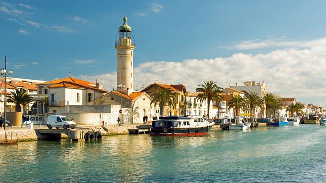 Canal and lighthouse in Grau du Roi, Camargue, France.