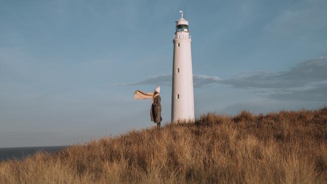 A visitor takes in the peaceful views around Cape Wickham Lighthouse. Picture: Emilie Ristevski/Tourism Tasmania.