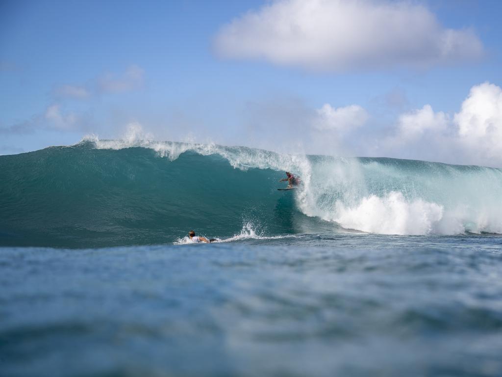 Ezekiel Lau tucks inside a barrel as Jack Robinson paddles.