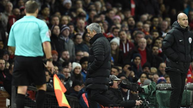 Manchester United's Portuguese manager Jose Mourinho (C) leaves the touchline.