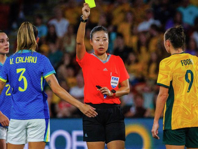 Australia's Caitlin Foord (R) and Brazil's Vitoria Calhau (2nd L) both receive the yellow card during the women's international football friendly match between Australia and Brazil at Suncorp Stadium in Brisbane on November 28, 2024. (Photo by Patrick HAMILTON / AFP) / -- IMAGE RESTRICTED TO EDITORIAL USE - STRICTLY NO COMMERCIAL USE --