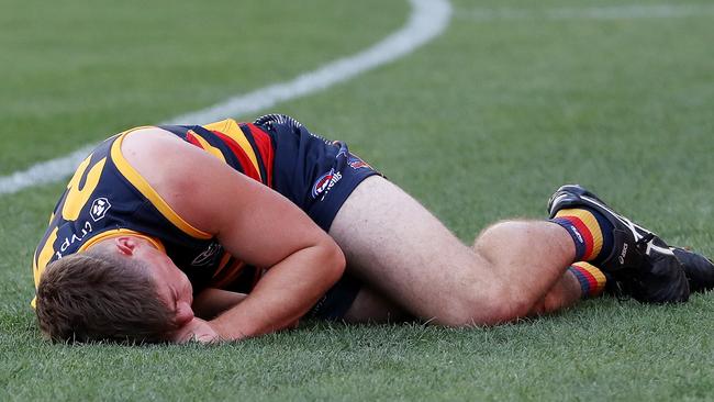 ADELAIDE, AUSTRALIA - MARCH 25: Patrick Parnell of the Crows on the ground and hurt after being tackled by Nathan Broad of the Tigers during the 2023 AFL Round 02 match between the Adelaide Crows and the Richmond Tigers at Adelaide Oval on March 25, 2023 in Adelaide, Australia. (Photo by Sarah Reed/AFL Photos via Getty Images)