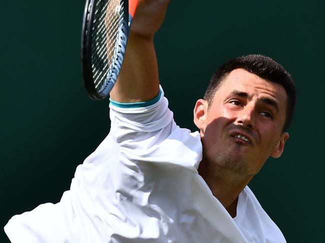 Australia's Bernard Tomic serves against France's Jo-Wilfried Tsonga during their men's singles first round match on the second day of the 2019 Wimbledon Championships at The All England Lawn Tennis Club in Wimbledon, southwest London, on July 2, 2019. (Photo by Ben STANSALL / AFP) / RESTRICTED TO EDITORIAL USE