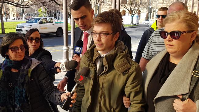 Callum Nelsen Shannon, centre, outside the District Court, where he received a suspended sentence for killing his friend in a car crash. Picture: Sean Fewster.