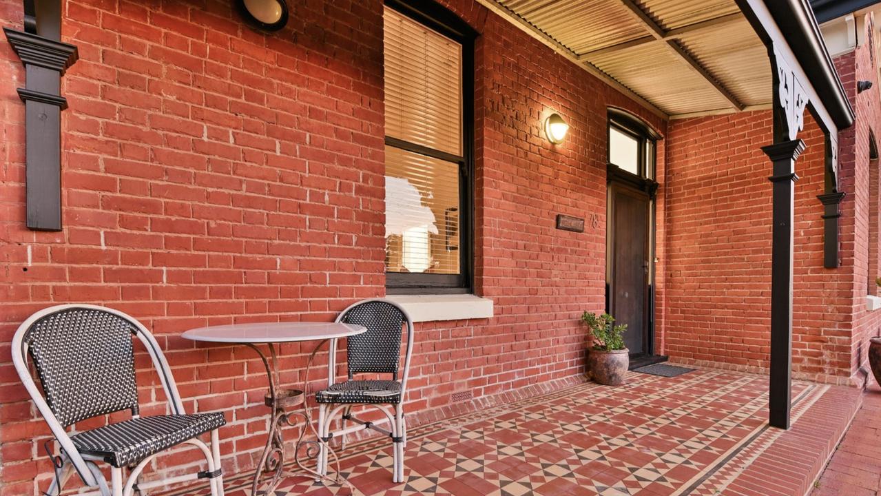 The front porch of the home still displaying its old school charm