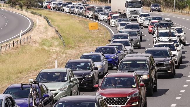 Cars backing up on the Hume Freeway to cross the border into Victoria on New Year’s Eve. Picture: Simon Dallinger