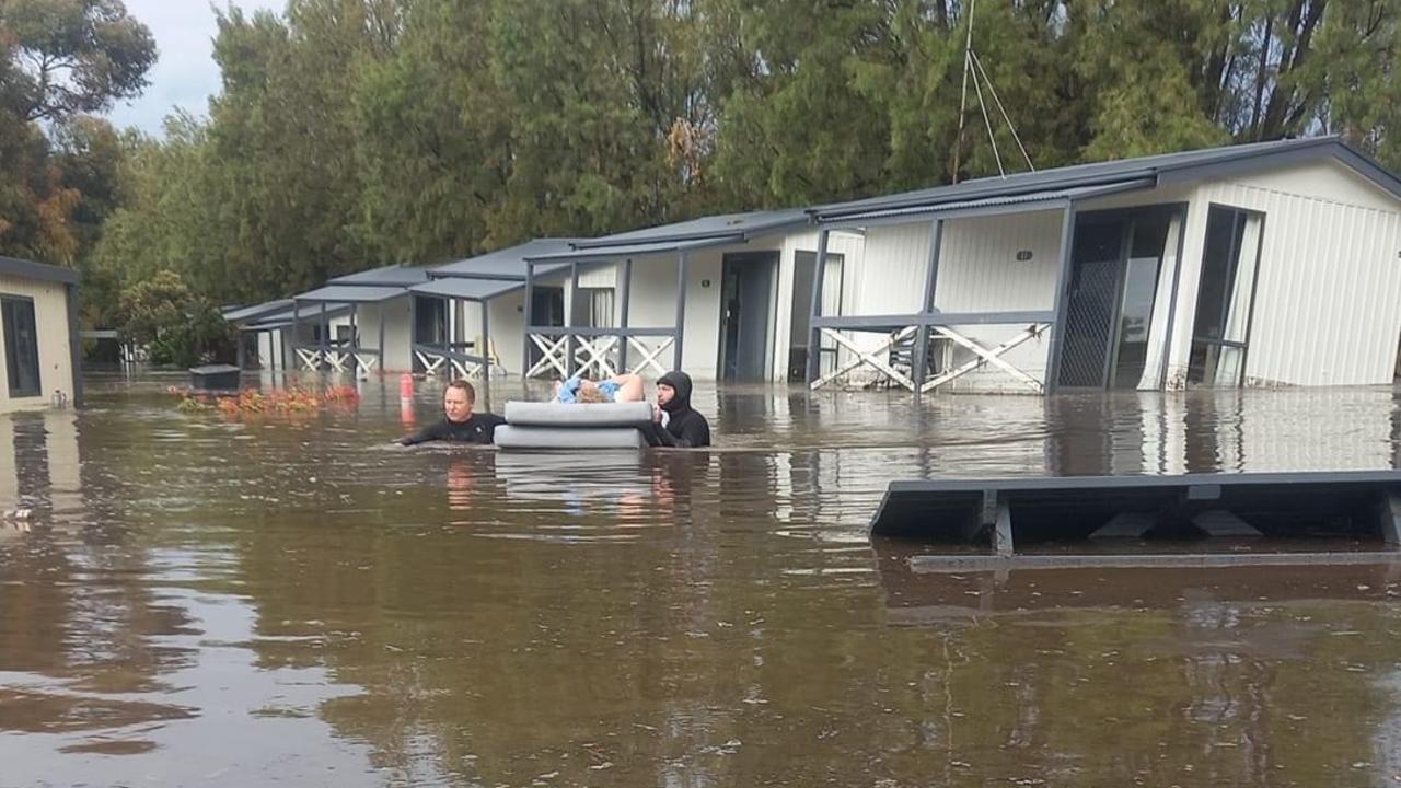 Helen Schulz being rescued after floods at Middleton Caravan Park.