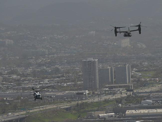 US President Donald Trump’s helicopter, Marine One (left), flies over Puerto Rico, with many parts of the island remaining without access to power or drinking water. Picture: Mandel Ngan/AFP