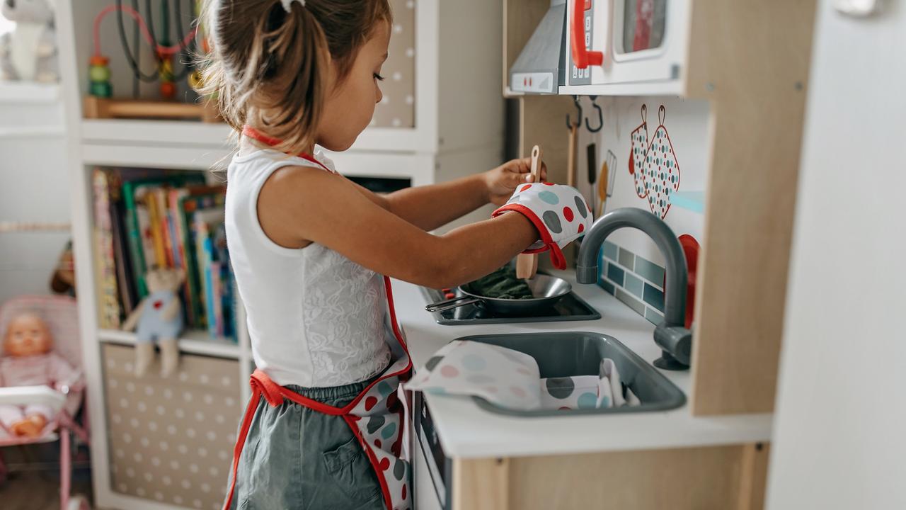 Girl playing in the mini kitchen