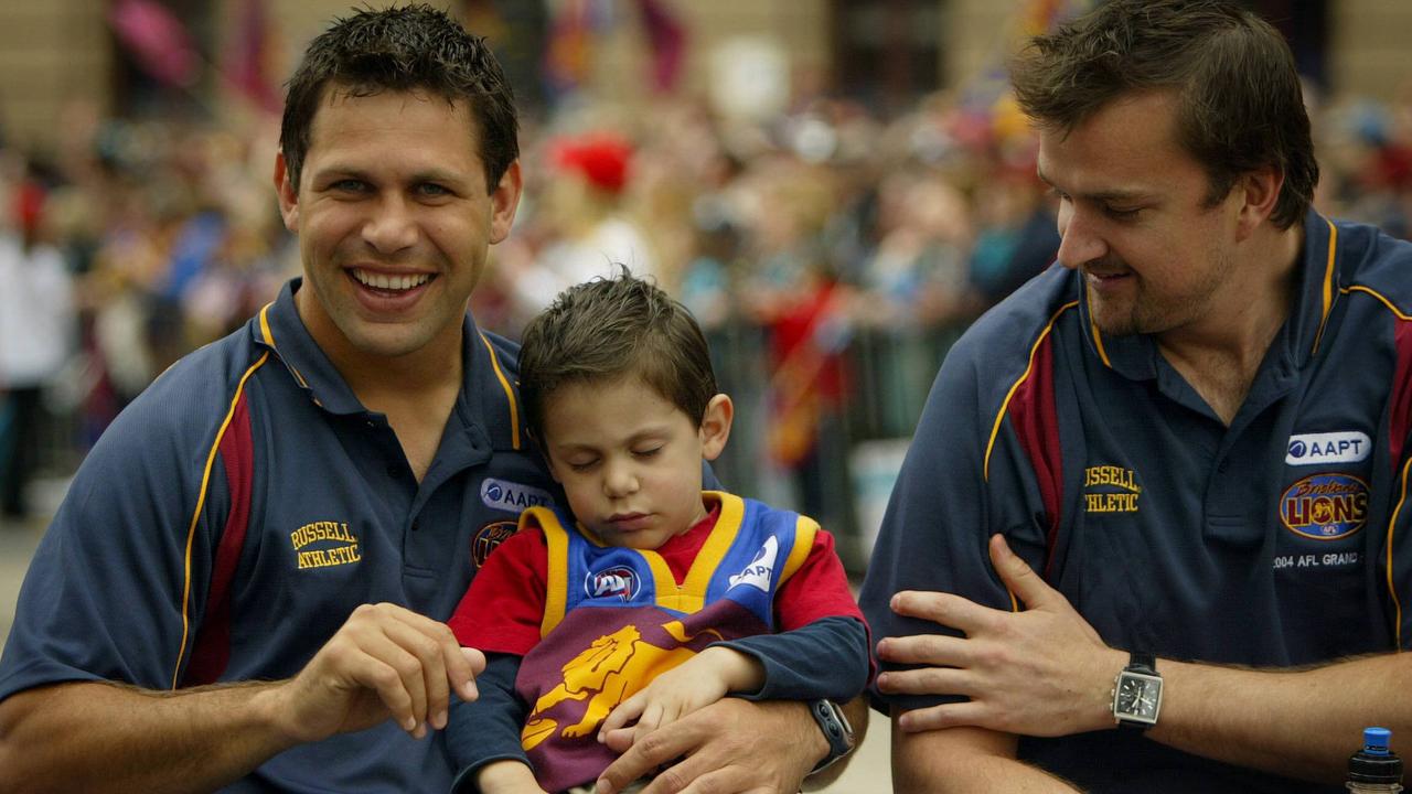 Brisbane great Chris Johnson with his son Lachlan and Clark Keating during the 2004 Grand Final Parade in Melbourne.