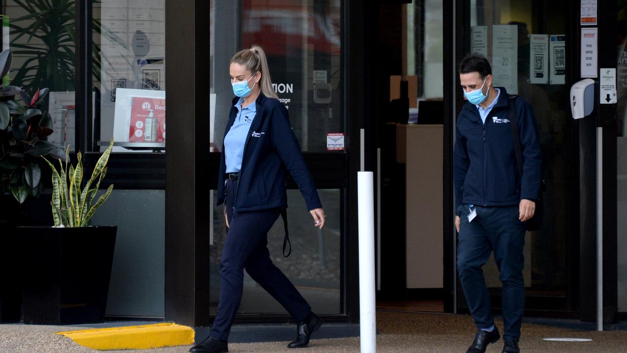 Health Department staff leave the Holiday Inn. Picture: NCA NewsWire / Andrew Henshaw.