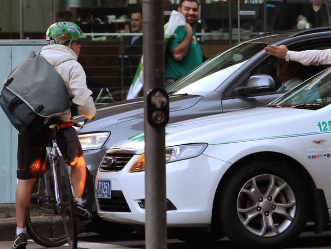 A cyclist and taxi driver exchange heated words at the intersection of Castlereagh St and Goulburn St in the city. motorist, anger, fight, shouting, car, vehicle, bike,