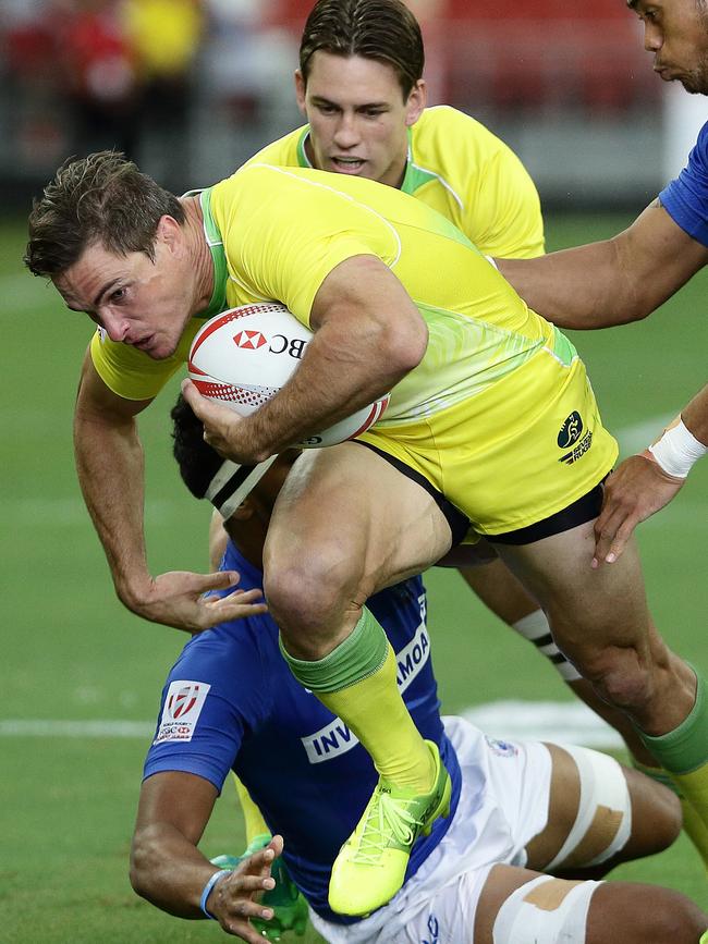 Ed Jenkins of Australia is tackled by Savelio Ropati of Samoa during a 2017 Singapore Sevens match between Australia and Samoa.