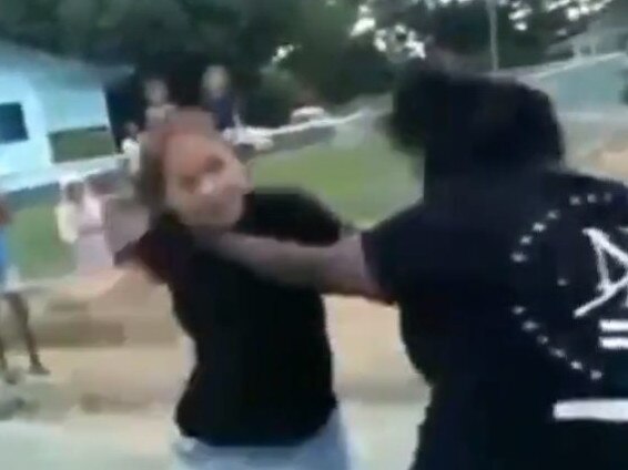 A screenshot of a YouTube video of two women brawling on the streets of Palm Island.