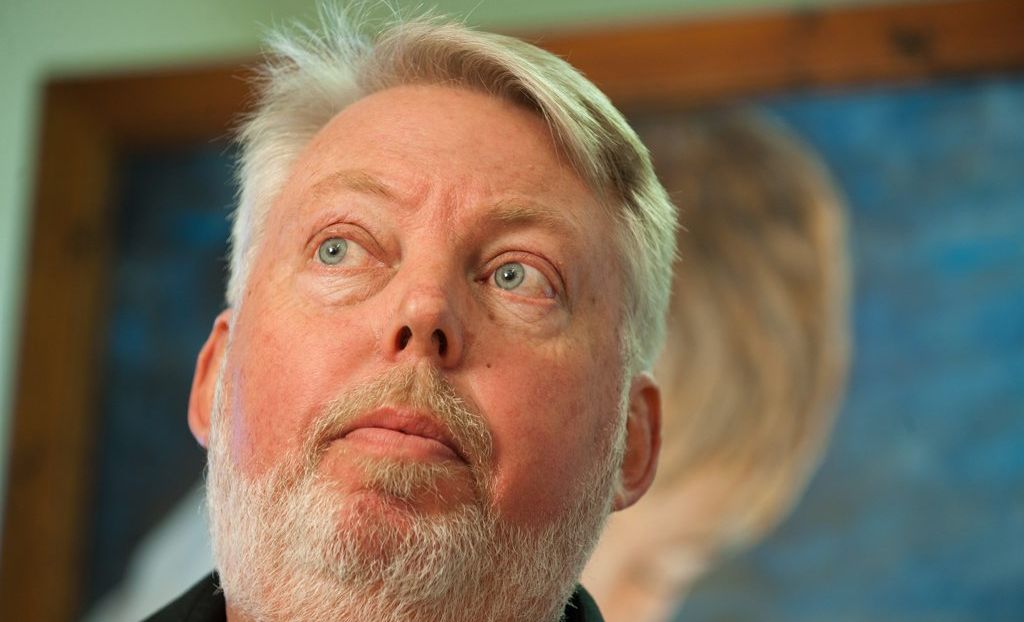 Bruce Morcombe with a painting of Daniel behind him. Picture: Warren Lynam
