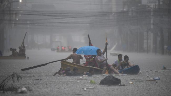 … to devastating monsoons? (Pictured: Manila in the Philippines). Picture: Ted ALJIBE / AFP