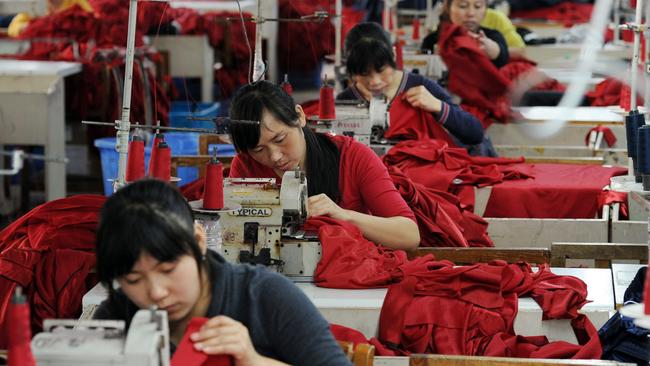 Chinese workers stitch clothes for export to Europe at a textile factory in Hefei, in eastern China’s Anhui province. Picture: AFP