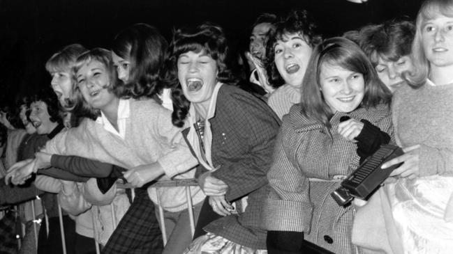 The Beatles fans at Sydney Airport as band members arrive for 1964 Australian tour.