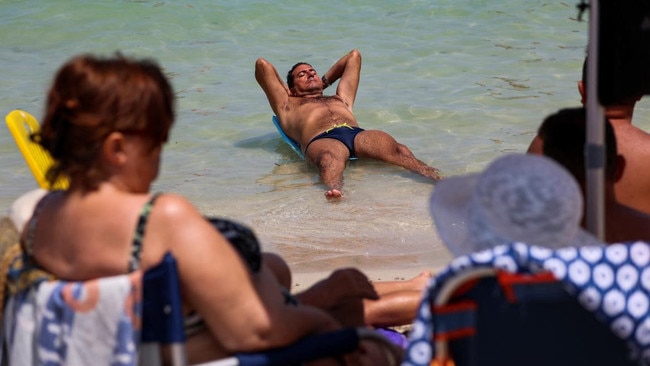 A man cools off in the sea at Mondello beach in Palermo, Italy. Picture: Reuters/The Times