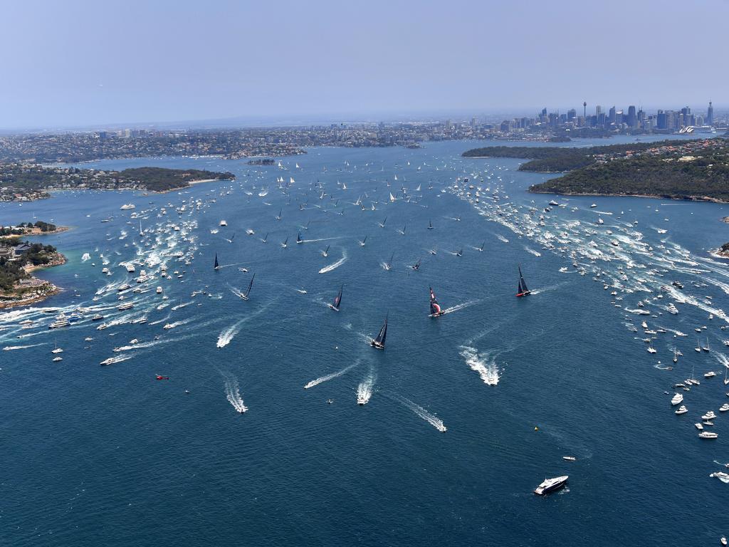 Info Track leads the fleet through Sydney Harbour following the start of the Sydney to Hobart Yacht race in Sydney, Thursday, December 26, 2019. (AAP Image/Dean Lewins)