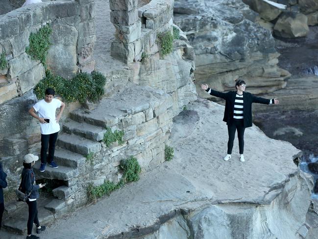 People take photos at cliffs of Diamond Bay in Vaucluse. Picture: Damian Shaw