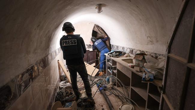 Journalists inside a tunnel that Israel is a "Hamas command tunnel" under a compound of the United Nations Relief and Works Agency for Palestine Refugees (UNRWA) in Gaza. Picture: AFP