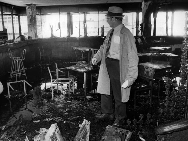 Inspector LJ Bardwell of CIB Scientific Section inspects the damage at the Brisbane club.