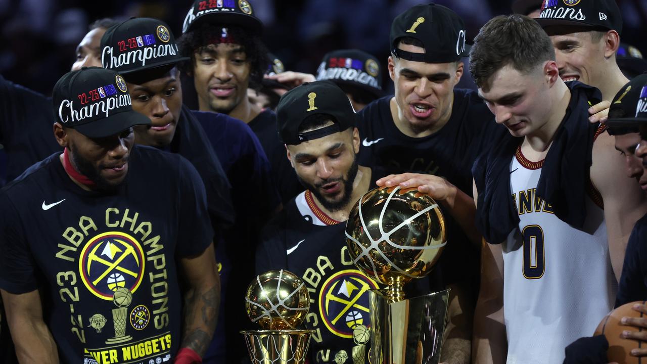 DENVER, COLORADO - JUNE 12: The Denver Nuggets celebrate with the Larry O'Brien Championship Trophy after a 94-89 victory against the Miami Heat in Game Five of the 2023 NBA Finals to win the NBA Championship at Ball Arena on June 12, 2023 in Denver, Colorado. NOTE TO USER: User expressly acknowledges and agrees that, by downloading and or using this photograph, User is consenting to the terms and conditions of the Getty Images License Agreement. (Photo by Matthew Stockman/Getty Images)