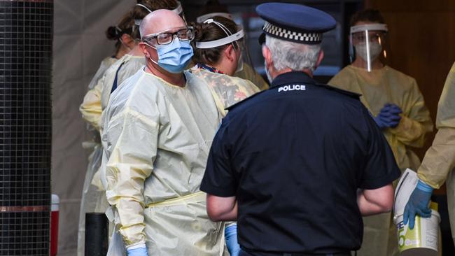 Medical staff with police, outside the Peppers medi-hotel last month. Picture: Brenton Edwards