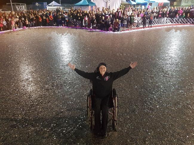 Connie Johnson in a heart of 5 cent pieces at the end of the Big Heart Project. Picture: Love Your Sister/Facebook