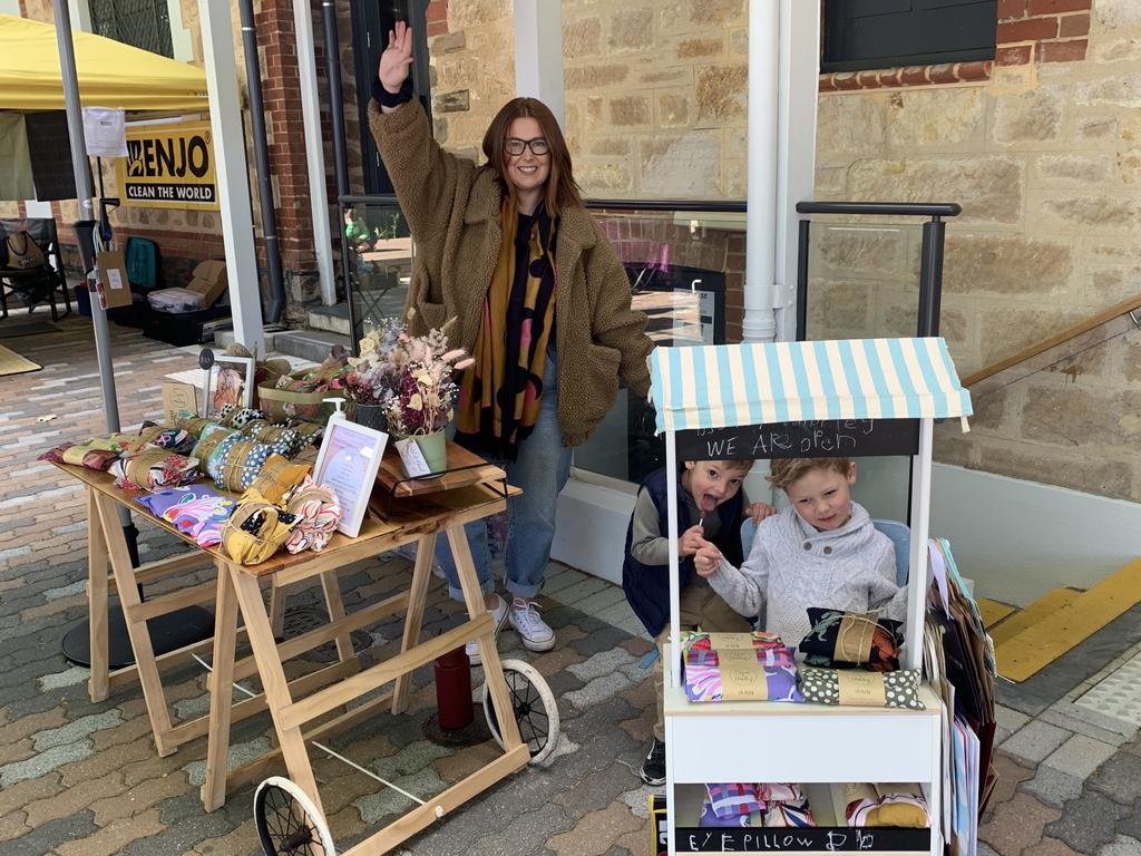 Lily Davis and her sons Oscar and Harley manning the stall at her side hustle heat pack business Oscar &amp; Harley. Picture: Supplied