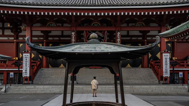 A man prays at Tokyo’s Senso-ji Temple as Japan continues to struggle with Covid-19 amid vaccine shortages and the Paralympic Games. Picture: Getty Images.