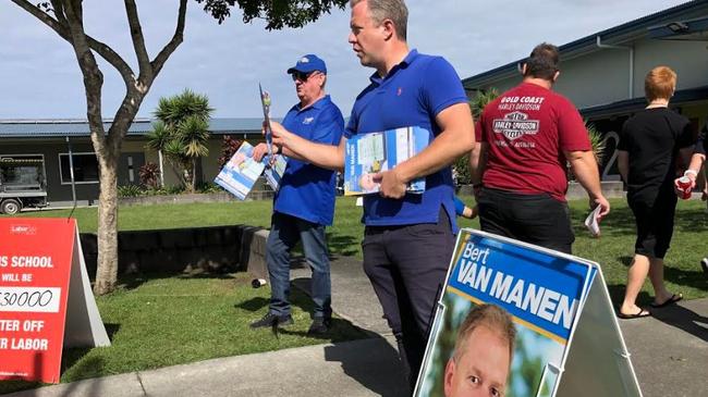 Burleigh MP Michael Hart and Councillor Cameron Caldwell handing how-to-vote cards in the northern Gold Coast seat of Forde.